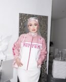 Woman wearing a stylish Pink Ferrari Jacket, a women’s Ferrari racing jacket with a sleek motorsport-inspired design, perfect for streetwear fashion.