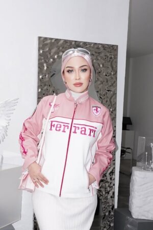 Woman wearing a stylish Pink Ferrari Jacket, a women’s Ferrari racing jacket with a sleek motorsport-inspired design, perfect for streetwear fashion.