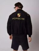 Model wearing the Porsche bomber jacket, pairing streetwear aesthetics with motorsport heritage.