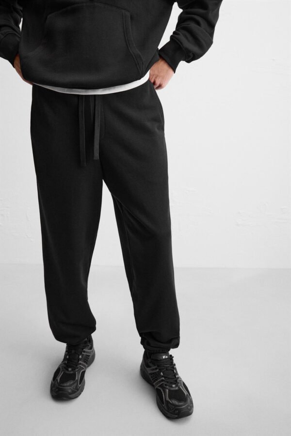 Close-up of Zerodas Classic Black Track Pant highlighting drawstring waistband and modern jogger style