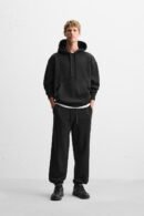 Zerodas Classic Black Track Pant styled for urban streetwear, shown on model with casual black sneakers