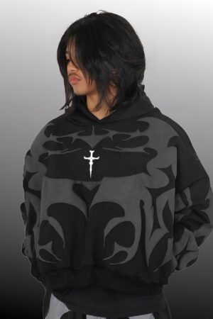 Male model wearing black oversized depth hoodie in urban street setting