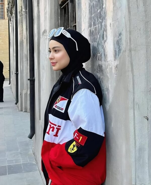 Front view of Ferrari zip-up jacket showcasing full-length zipper and embroidered Formula 1 team patches.