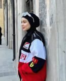 Front view of Ferrari zip-up jacket showcasing full-length zipper and embroidered Formula 1 team patches.