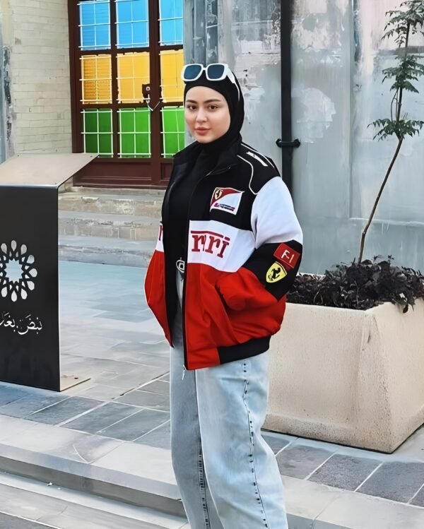 Model wearing a Ferrari F1 jacket by Zerodas, standing confidently with visible Scuderia Ferrari logo and racing details.