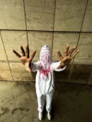 Model wearing white Spiderman hoodie with zip-up front